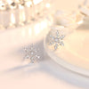 The Snow Queen II Jewellery Set - Crystal Tipped - A delicate snowflake-themed set of necklace and earrings, featuring snowflakes formed from textured silver with crystals set into the centre and tips.