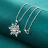 The Snow Queen II Jewellery Set - Crystal Tipped - A delicate snowflake-themed set of necklace and earrings, featuring snowflakes formed from textured silver with crystals set into the centre and tips.