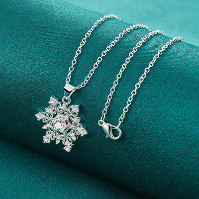 The Snow Queen II Jewellery Set - Crystal Tipped - A delicate snowflake-themed set of necklace and earrings, featuring snowflakes formed from textured silver with crystals set into the centre and tips.