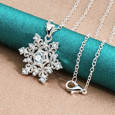 The Snow Queen II Jewellery Set - Crystal Tipped - A delicate snowflake-themed set of necklace and earrings, featuring snowflakes formed from textured silver with crystals set into the centre and tips.