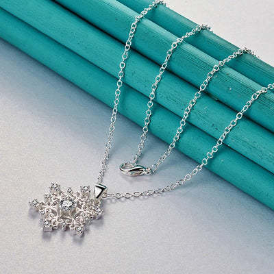 The Snow Queen II Jewellery Set - Crystal Tipped - A delicate snowflake-themed set of necklace and earrings, featuring snowflakes formed from textured silver with crystals set into the centre and tips.
