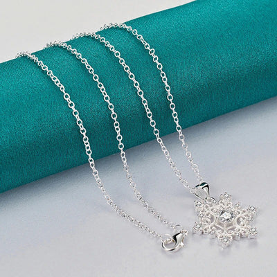 The Snow Queen II Jewellery Set - Crystal Tipped - A delicate snowflake-themed set of necklace and earrings, featuring snowflakes formed from textured silver with crystals set into the centre and tips.