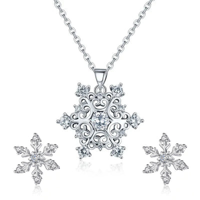 The Snow Queen II Jewellery Set - Crystal Tipped - A delicate snowflake-themed set of necklace and earrings, featuring snowflakes formed from textured silver with crystals set into the centre and tips.