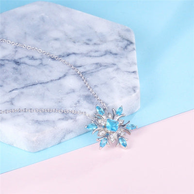 The Snow Queen II Jewellery Set - A beautiful snowflake pendant and earrings with blue topaz and white quartz stones.