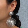 Solaris Radiant Statement Earrings - Large statement earrings featuring a round starburst shape with long rays radiating out from a central pearl.