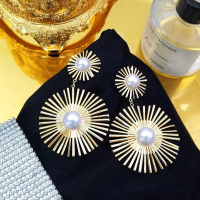 Solaris Radiant Statement Earrings - Large statement earrings featuring a round starburst shape with long rays radiating out from a central pearl.