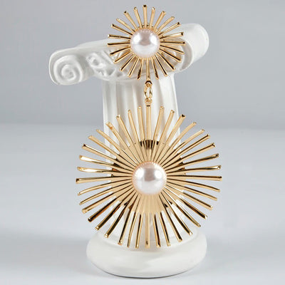 Solaris Radiant Statement Earrings - Large statement earrings featuring a round starburst shape with long rays radiating out from a central pearl.