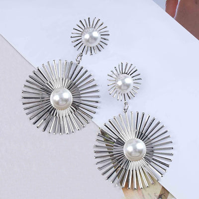 Solaris Radiant Statement Earrings - Large statement earrings featuring a round starburst shape with long rays radiating out from a central pearl.