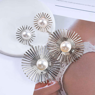 Solaris Radiant Statement Earrings - Large statement earrings featuring a round starburst shape with long rays radiating out from a central pearl.