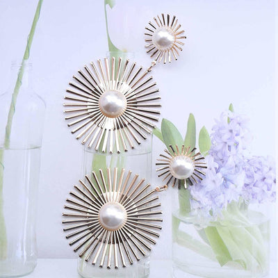 Solaris Radiant Statement Earrings - Large statement earrings featuring a round starburst shape with long rays radiating out from a central pearl.