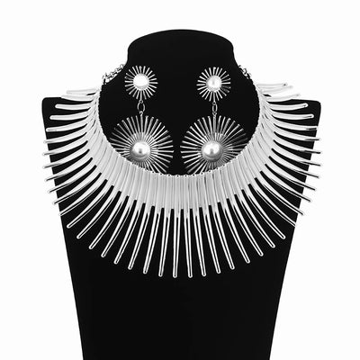 Solaris Radiant Statement Set - A pair of matching earrings and collar featuring long metal rays radiating out from a centre point, like solar rays.