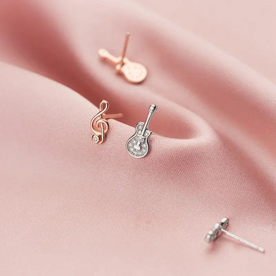 Stefani Music Note & Instrument Crystal Stud Earrings - A pair of teeny tiny asymmetrical stud earrings, one a music note and one a little stylised guitar, made from beautiful 925 Sterling Silver and 14 karat rose gold.