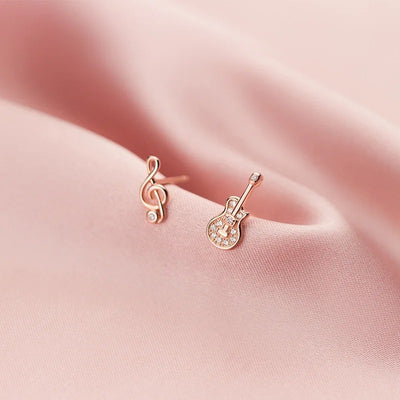 Stefani Music Note & Instrument Crystal Stud Earrings - A pair of teeny tiny asymmetrical stud earrings, one a music note and one a little stylised guitar, made from beautiful 925 Sterling Silver and 14 karat rose gold.