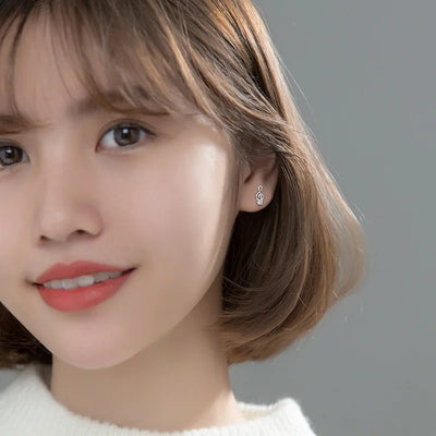 Stefani Music Note & Instrument Crystal Stud Earrings - A pair of teeny tiny asymmetrical stud earrings, one a music note and one a little stylised guitar, made from beautiful 925 Sterling Silver and 14 karat rose gold.