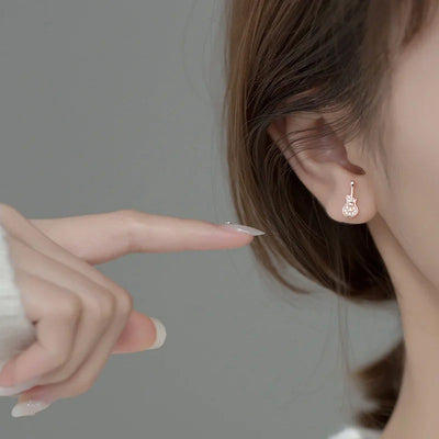 Stefani Music Note & Instrument Crystal Stud Earrings - A pair of teeny tiny asymmetrical stud earrings, one a music note and one a little stylised guitar, made from beautiful 925 Sterling Silver and 14 karat rose gold.