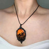 Sunset Ravens Cameo Necklace - A large gothic glass cabochon featuring an image of two silhouetted ravens or crows against a vibrant orange background.