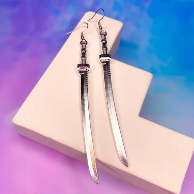 Takeko Gothic Katana Earrings - A pair of large, stylised dark silver toned stylised katana earrings.