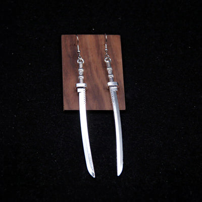 Takeko Gothic Katana Earrings - A pair of large, stylised dark silver toned stylised katana earrings.