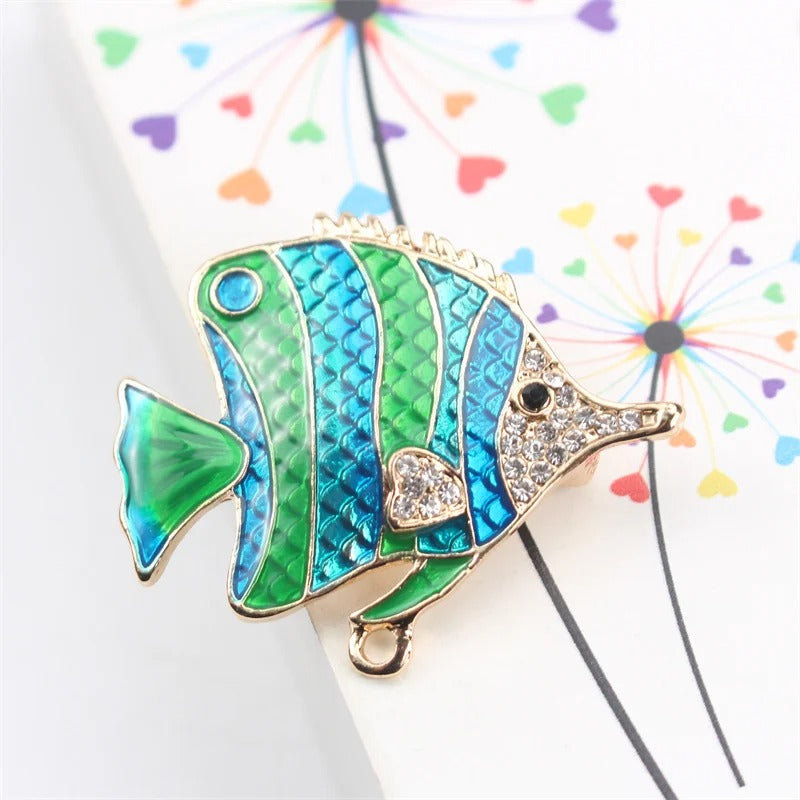 Tamika Enamel Angelfish Brooch - A brightly-coloured brooch shaped like a stylised fish, painted with alternating stripes of metallic blue and green enamel paint, and crystals around the head and fins.