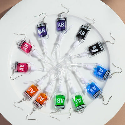 Teenytopia Alien Nurse Blood Bag - Cute, stylish Halloween earrings featuring a tiny bag of strangely-coloured blood and cables suspended from a French hook.