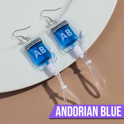 Teenytopia Alien Nurse Blood Bag - Cute, stylish Halloween earrings featuring a tiny bag of strangely-coloured blood and cables suspended from a French hook.