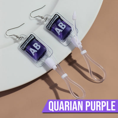 Teenytopia Alien Nurse Blood Bag - Cute, stylish Halloween earrings featuring a tiny bag of strangely-coloured blood and cables suspended from a French hook.