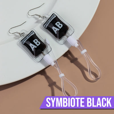 Teenytopia Alien Nurse Blood Bag - Cute, stylish Halloween earrings featuring a tiny bag of strangely-coloured blood and cables suspended from a French hook.