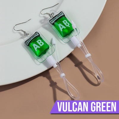 Teenytopia Alien Nurse Blood Bag - Cute, stylish Halloween earrings featuring a tiny bag of strangely-coloured blood and cables suspended from a French hook.