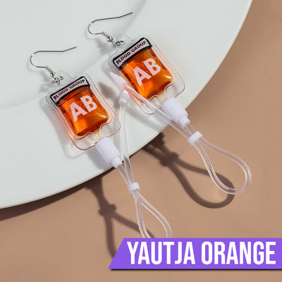 Teenytopia Alien Nurse Blood Bag - Cute, stylish Halloween earrings featuring a tiny bag of strangely-coloured blood and cables suspended from a French hook.