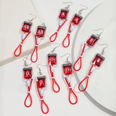 Teenytopia Naughty Nurse Blood Bag Earrings - Cute, stylish Halloween earrings featuring a tiny bag of blood and cables suspended from a French hook.