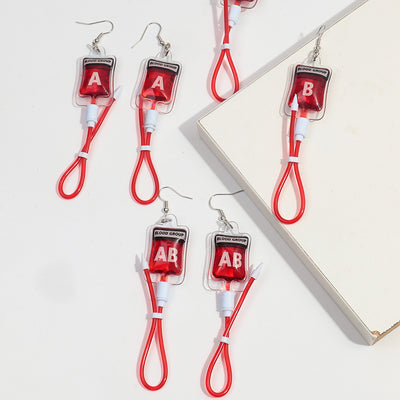 Teenytopia Naughty Nurse Blood Bag Earrings - Cute, stylish Halloween earrings featuring a tiny bag of blood and cables suspended from a French hook.