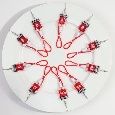 Teenytopia Naughty Nurse Blood Bag Earrings - Cute, stylish Halloween earrings featuring a tiny bag of blood and cables suspended from a French hook.