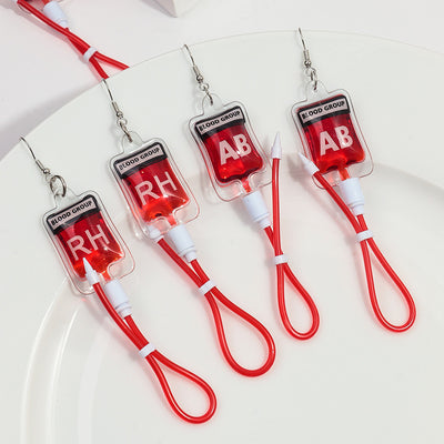 Teenytopia Naughty Nurse Blood Bag Earrings - Cute, stylish Halloween earrings featuring a tiny bag of blood and cables suspended from a French hook.