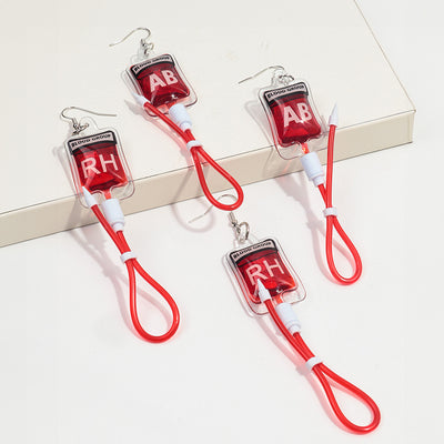 Teenytopia Naughty Nurse Blood Bag Earrings - Cute, stylish Halloween earrings featuring a tiny bag of blood and cables suspended from a French hook.