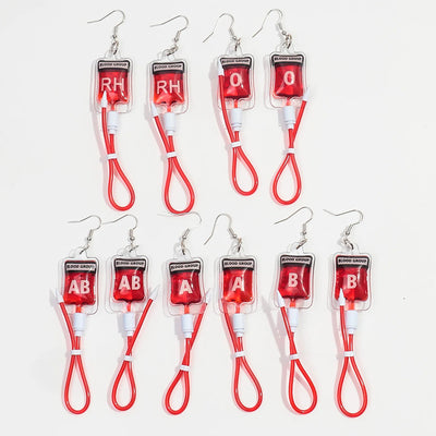 Teenytopia Naughty Nurse Blood Bag Earrings - Cute, stylish Halloween earrings featuring a tiny bag of blood and cables suspended from a French hook.