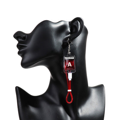 Teenytopia Naughty Nurse Blood Bag Earrings - Cute, stylish Halloween earrings featuring a tiny bag of blood and cables suspended from a French hook.