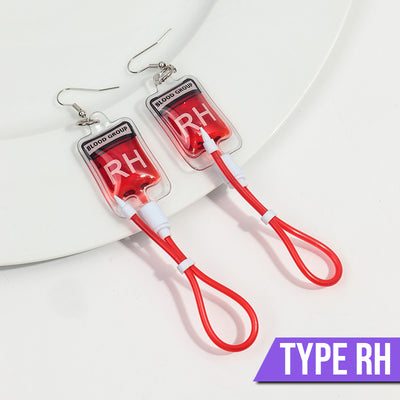 Teenytopia Naughty Nurse Blood Bag Earrings - Cute, stylish Halloween earrings featuring a tiny bag of blood and cables suspended from a French hook.