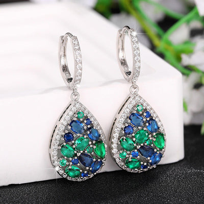 Terra Earth & Sky Crystal Drop Pendant & Earrings Set - An elegant teardrop-shaped pendant and earrings featuring a mixture of green and dark blue crystals, trimmed with delicate white crystals.