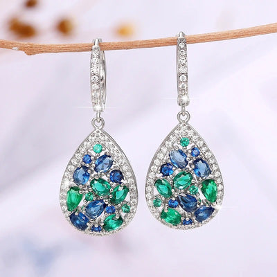 Terra Earth & Sky Crystal Drop Pendant & Earrings Set - An elegant teardrop-shaped pendant and earrings featuring a mixture of green and dark blue crystals, trimmed with delicate white crystals.