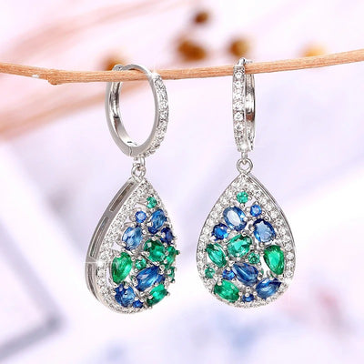 Terra Earth & Sky Crystal Drop Pendant & Earrings Set - An elegant teardrop-shaped pendant and earrings featuring a mixture of green and dark blue crystals, trimmed with delicate white crystals.