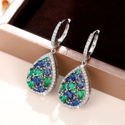 Terra Earth & Sky Crystal Drop Pendant & Earrings Set - An elegant teardrop-shaped pendant and earrings featuring a mixture of green and dark blue crystals, trimmed with delicate white crystals.
