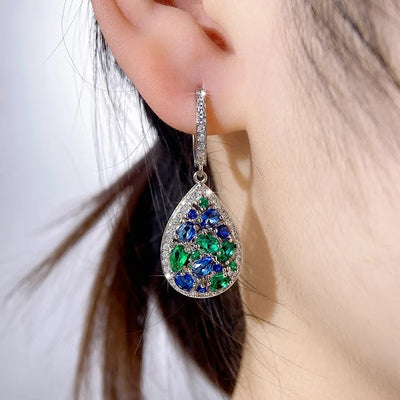Terra Earth & Sky Crystal Drop Pendant & Earrings Set - An elegant teardrop-shaped pendant and earrings featuring a mixture of green and dark blue crystals, trimmed with delicate white crystals.