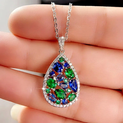 Terra Earth & Sky Crystal Drop Pendant & Earrings Set - An elegant teardrop-shaped pendant and earrings featuring a mixture of green and dark blue crystals, trimmed with delicate white crystals.