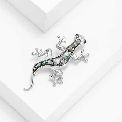 Tropicana Mo'o Gecko Brooch - A stylised silver-toned zinc alloy gecko brooch adorned with polished paua shell and artificial crystals.