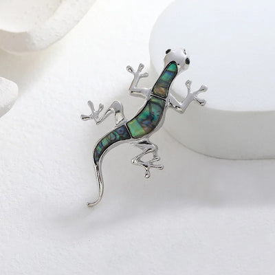 Tropicana Mo'o Gecko Brooch - A stylised silver-toned zinc alloy gecko brooch adorned with polished paua shell and artificial crystals.