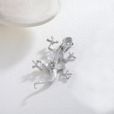 Tropicana Mo'o Gecko Brooch - A stylised silver-toned zinc alloy gecko brooch adorned with polished paua shell and artificial crystals.
