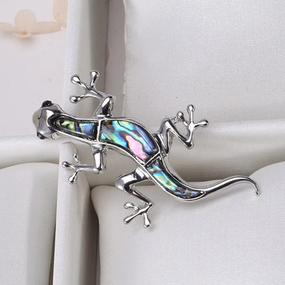 Tropicana Mo'o Gecko Brooch - A stylised silver-toned zinc alloy gecko brooch adorned with polished paua shell and artificial crystals.
