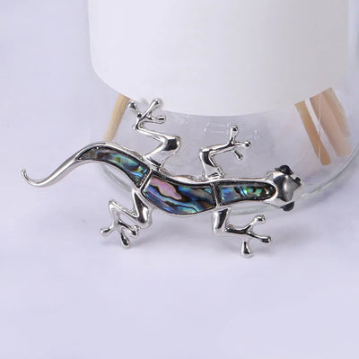 Tropicana Mo'o Gecko Brooch - A stylised silver-toned zinc alloy gecko brooch adorned with polished paua shell and artificial crystals.