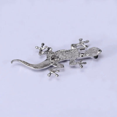 Tropicana Mo'o Gecko Brooch - A stylised silver-toned zinc alloy gecko brooch adorned with polished paua shell and artificial crystals.