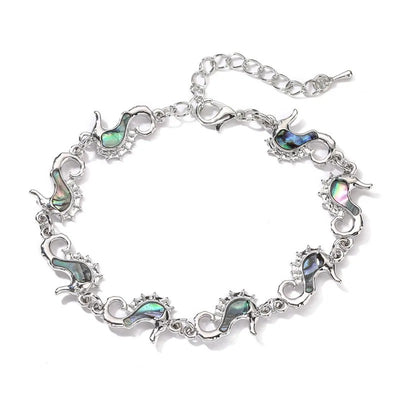 The Tropicana Mo'o Lio Seahorse Bracelet - A beautiful silver seahorse bracelet adorned with lovely polished paua shell.